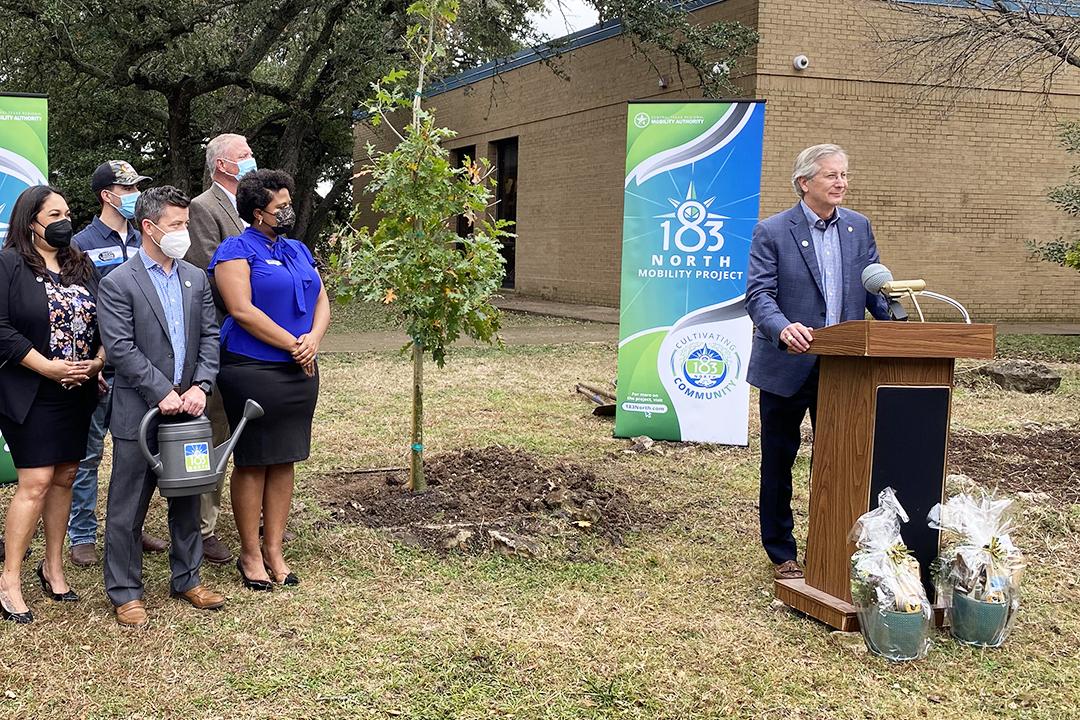 Central Texas Regional Mobility Authority Chairman of the Board of Directors Bobby Jenkins stands at a podium.